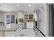 Open kitchen featuring stainless steel appliances, granite countertops, and access to the backyard through a sliding glass door at 509 Regal Robin Way, North Las Vegas, NV 89084