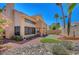 Landscaped backyard with mature trees, garden beds, rock features, and a private patio area at 5237 Crooked Sky Cir, Las Vegas, NV 89149