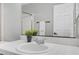 Bathroom featuring a white sink with chrome faucet, a decorative plant and white tile countertop at 5237 Crooked Sky Cir, Las Vegas, NV 89149