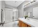 Bright bathroom featuring a tub-shower combination with sliding glass doors and a well-lit vanity at 5237 Crooked Sky Cir, Las Vegas, NV 89149