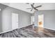 This airy bedroom has wood floors, a ceiling fan, and an en-suite bathroom at 5237 Crooked Sky Cir, Las Vegas, NV 89149