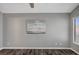 A minimalist bedroom features gray walls, white trim, and wood-look floors at 5237 Crooked Sky Cir, Las Vegas, NV 89149