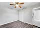 This spacious bedroom features a ceiling fan, closet, and modern gray wood-look flooring at 5237 Crooked Sky Cir, Las Vegas, NV 89149