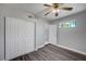 This bedroom features a ceiling fan, closet, modern gray wood-look flooring and a window at 5237 Crooked Sky Cir, Las Vegas, NV 89149