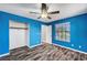 This blue bedroom is complete with wood-look floors, a ceiling fan, and a closet at 5237 Crooked Sky Cir, Las Vegas, NV 89149