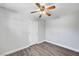 This bedroom features a ceiling fan, modern gray wood-look flooring, and neutral paint at 5237 Crooked Sky Cir, Las Vegas, NV 89149