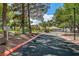 Well-maintained entrance to the Golf Club at Painted Desert featuring mature trees and professional landscaping at 5237 Crooked Sky Cir, Las Vegas, NV 89149
