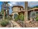 Exterior view of the Painted Desert community center featuring a terracotta tile roof and beautiful landscaping at 5237 Crooked Sky Cir, Las Vegas, NV 89149