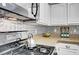 Close up of the kitchen, with black gas range and decorative backsplash at 5237 Crooked Sky Cir, Las Vegas, NV 89149
