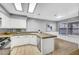 Bright kitchen with white cabinets, stainless steel appliances and stone countertops at 5237 Crooked Sky Cir, Las Vegas, NV 89149