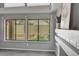 Window view overlooking landscaped backyard and a tiled fireplace mantle with plants and artwork at 5237 Crooked Sky Cir, Las Vegas, NV 89149