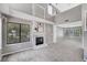 Open-concept living room with a fireplace, large windows, and a view of the landscaped exterior at 5237 Crooked Sky Cir, Las Vegas, NV 89149