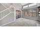Bright and airy living area featuring a staircase, large windows, and sliding glass door at 5237 Crooked Sky Cir, Las Vegas, NV 89149