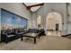 Comfortable lounge area with large mural, featuring leather sofas and chairs and access to other areas at 5237 Crooked Sky Cir, Las Vegas, NV 89149