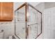 Glass enclosed shower with bronze hardware and tile surround at 5237 Crooked Sky Cir, Las Vegas, NV 89149