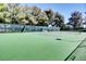 Well-maintained tennis court surrounded by trees, offering a great place for outdoor recreation and exercise at 5237 Crooked Sky Cir, Las Vegas, NV 89149