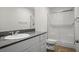 Bathroom featuring a granite countertop, and a shower with glass doors at 532 Clearsable Ave, Henderson, NV 89044