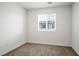 This bedroom features neutral carpet, white walls, and a window providing natural light at 532 Clearsable Ave, Henderson, NV 89044