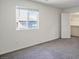 Bright bedroom featuring a large window, neutral walls, and a walk-in closet at 532 Clearsable Ave, Henderson, NV 89044