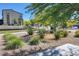 A well-manicured front yard featuring lush greenery with decorative rocks and green grass at 532 Clearsable Ave, Henderson, NV 89044