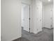 Hallway featuring gray carpet and neutral walls leading to various rooms at 532 Clearsable Ave, Henderson, NV 89044