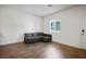Cozy living room showcasing hardwood floors, a comfortable sofa, and lots of natural light at 532 Clearsable Ave, Henderson, NV 89044