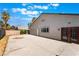 Spacious backyard featuring a concrete patio, stucco house, and some landscaping at 5336 Regal Ave, Las Vegas, NV 89146