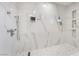 Elegant bathroom showing a walk-in shower with marble-like tiling, built-in niches, and modern fixtures at 5336 Regal Ave, Las Vegas, NV 89146