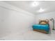 Neutral colored bedroom featuring a comfortable bed and sleek modern tile flooring at 5336 Regal Ave, Las Vegas, NV 89146