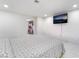 Bright bedroom includes a television and view of a walk-in closet at 5336 Regal Ave, Las Vegas, NV 89146