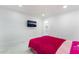 Well-lit bedroom featuring sleek modern tiling and equipped with a TV for entertainment at 5336 Regal Ave, Las Vegas, NV 89146