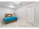 Neutral colored bedroom featuring a comfortable bed and sleek modern tile flooring at 5336 Regal Ave, Las Vegas, NV 89146