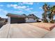 Single-story home with a modern gray garage door and red brick landscaping at 5336 Regal Ave, Las Vegas, NV 89146