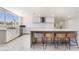 Modern kitchen featuring sleek countertops, a stylish island with seating, and stainless steel appliances at 5336 Regal Ave, Las Vegas, NV 89146