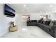 Spacious living area with a comfortable sectional and sleek marble floors at 5336 Regal Ave, Las Vegas, NV 89146