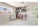 Bright walk-in closet featuring a clothing rack, modern tiled floor, and natural light from the window at 5336 Regal Ave, Las Vegas, NV 89146