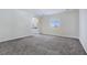 Spacious bedroom featuring neutral walls, carpet floors, and an open doorway to an attached bathroom at 5500 Santovito St, Pahrump, NV 89061