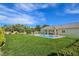Expansive backyard featuring a refreshing swimming pool, lush lawn, and covered patio at 5500 Santovito St, Pahrump, NV 89061