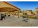 Large covered backyard patio with outdoor kitchen and a hammock on the yard at 5642 Breckenridge St, North Las Vegas, NV 89081