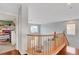 Second floor landing with wood floors and railing overlooking the living room at 5642 Breckenridge St, North Las Vegas, NV 89081