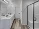 Bright bathroom with double vanity, modern lighting, and glass-enclosed shower, highlighting a clean design at 5709 Jaysin Douglas St, North Las Vegas, NV 89031
