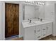 Bathroom featuring a barn door, double vanity with modern fixtures, and black hardware at 5709 Jaysin Douglas St, North Las Vegas, NV 89031