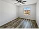 Bright bedroom featuring a large window, ceiling fan, and attractive wood-look floors at 5709 Jaysin Douglas St, North Las Vegas, NV 89031