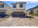 Inviting two-story home with neutral stucco and an attached two-car garage, showcasing modern curb appeal at 5709 Jaysin Douglas St, North Las Vegas, NV 89031