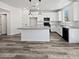 Modern kitchen features a center island, stainless appliances and pendant lighting at 5709 Jaysin Douglas St, North Las Vegas, NV 89031