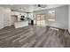 Open floor plan with modern kitchen, island, and sliding glass doors, creating a seamless flow to the outdoors at 5709 Jaysin Douglas St, North Las Vegas, NV 89031