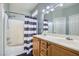 Clean bathroom featuring a double sink vanity, shower-tub combination, and modern fixtures at 6321 Rolling Rose St # 201, North Las Vegas, NV 89081