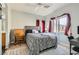 Comfortable bedroom with a cozy bed, patterned carpet, wooden desk, and natural light at 6321 Rolling Rose St # 201, North Las Vegas, NV 89081