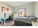 Bright bedroom with a patterned carpet, bed with storage, desk, and natural light at 6321 Rolling Rose St # 201, North Las Vegas, NV 89081