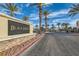 Community entrance sign surrounded by palm trees at 6321 Rolling Rose St # 201, North Las Vegas, NV 89081